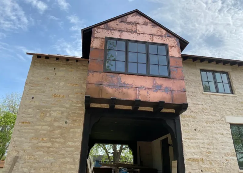 Copper metal panel facade on a stone building for Skylight Installation in Lake Los Angeles
